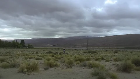Young Man Walking Alone In Vast Rural Landscape Video stock 332244705