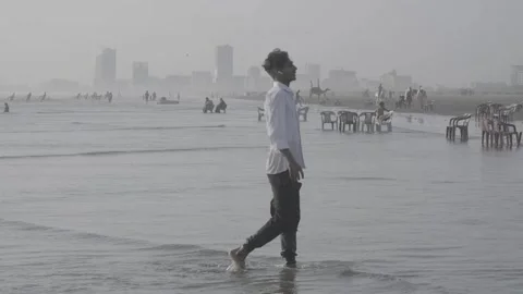 A young man walking along the beach in Karachi, Pakistan Stock-Footage 343875722