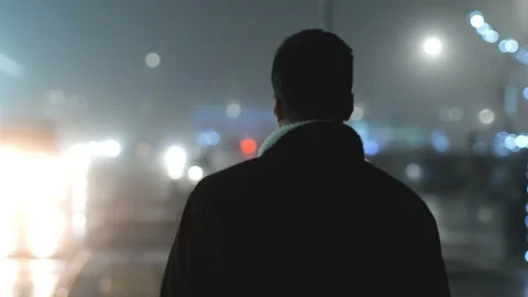 The young man walking along the evening street. slow motion Stock Footage 167006324