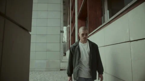Young man walking and looking at camera Stock Footage 258273832