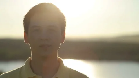 Young Man Walking and Raising Hands in the Wheat Field at Sunset Time Stock Footage 79073571