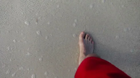 Young man walking barefoot on the beach Stock Footage 34506062