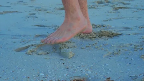 A young man walking on a beach in the early morning Stock Footage 108712416
