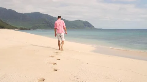 Young Man walking on the beach Stock Footage 66500876