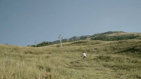 Young Man Walking Calmly Up a Hill Stock Footage 314644486