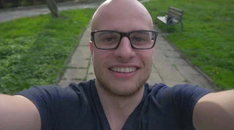 Young man walking with camera and filming his happy face. Stock Footage 62520642
