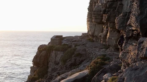 Young man walking on a cliff in the sunset into a viewpoint. Stock Footage 127427029