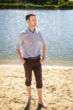 Young man walking on cost river Stock Photos