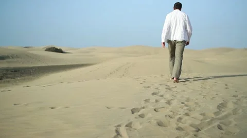 Young man walking in the desert HD Stock Footage 10901851