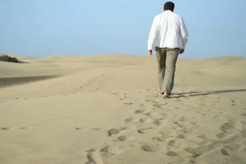 Young man walking in the desert NTSC Stock Footage 10901852