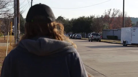 Young Man Walking Down City Sidewalk At Sunset Video stock 99427282