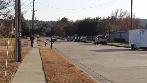 Young Man Walking Down City Sidewalk At Sunrise Video stock 99925673