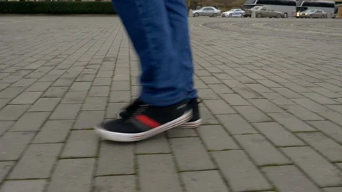 Young man walking down a city sidewalk in slow motion Stock Footage 106746990