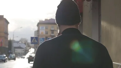 Young man walking down a sidewalk, slow motion. Stock-Footage 69990432