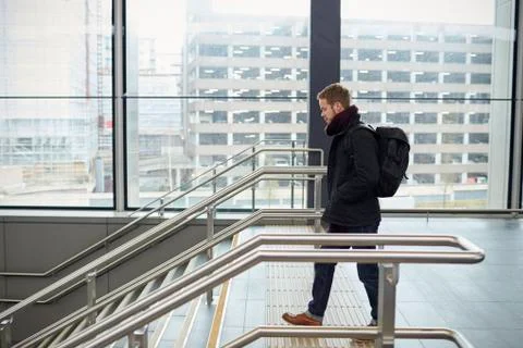 Young Man Walking Down Stairs In Railway Station Stock Photos