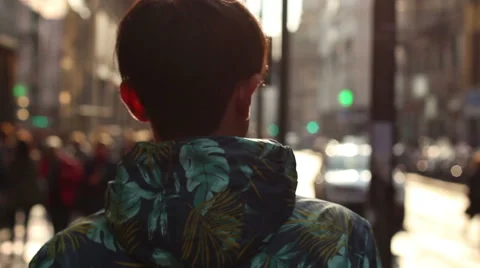 A young man walking down the street in the city. Milan, Italy. Steadicam shot Stock Footage 60240185