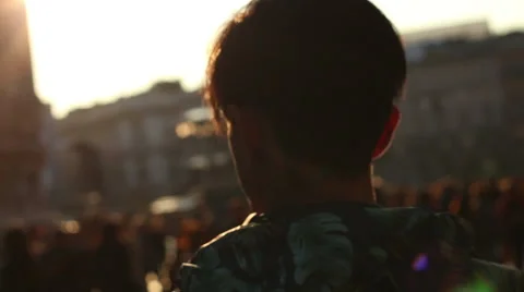 A young man walking down the street, sunny day. Milan, Italy. Steadicam shot Stock Footage 60240207