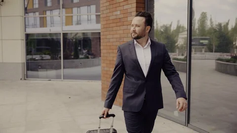Young man walking down the street Stock Footage 129552628