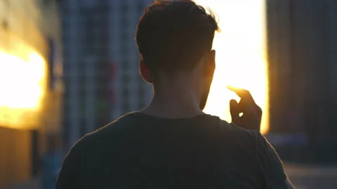 The young man walking in the evening sunlight. slow motion Stock Footage 140629881