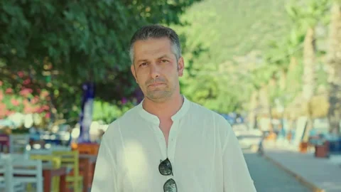 Young man walking on a flowery path in the background. Stock Footage 166001462
