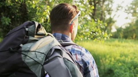 Young Man Walking in the Forest. The Sun is Shining Stock Footage 76560745