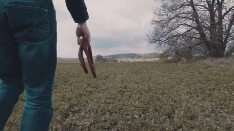Young man walking with his yellow labrador across the field Stock Footage 77170973