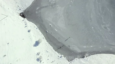 Young man walking on the ice. Top view of  frozen Lake Stock Footage 100632504