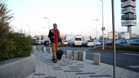 Young Man walking make Photo with Smart Phone on the Evening Street Wroclaw City Stock Footage 80505763