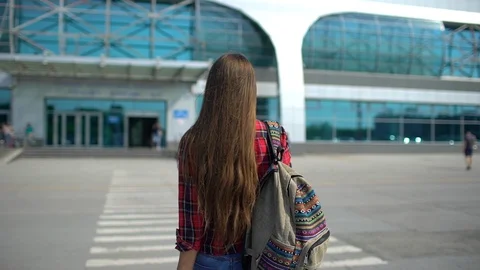 Young man walking to the modern airport terminal for her flight. View from the Stock Footage 95043553