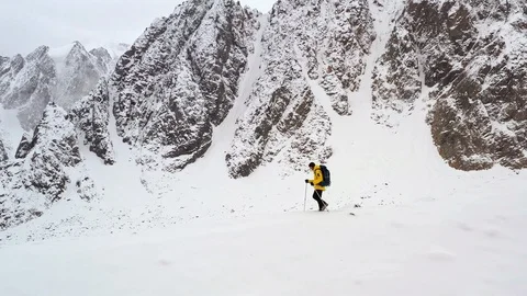 Young Man Walking Up Mountain Slope Backpacking Winter Hike Extreme Conditions Stock Footage 116609501