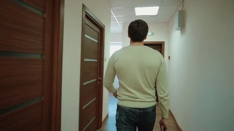 Young man walking into office Stock-Footage 72618026