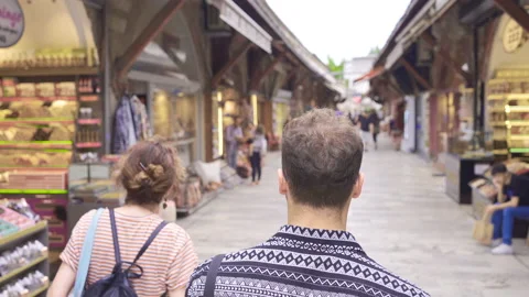 Young man walking in the old covered market. Video stock 212665403