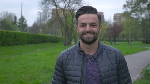 Young man walking in the park . Stock Footage 62735914