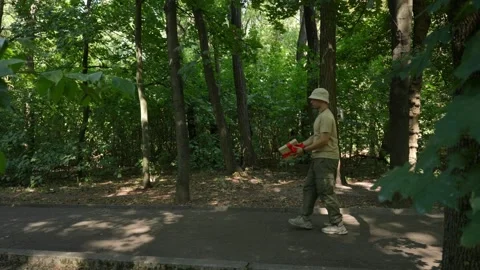 A young man walking in a park with a gift in his hands. Stock Footage 285220942
