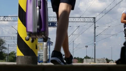 Young man walking on the platform and waiting for his train to arrive Stock Footage 78652718