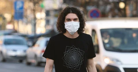 A young man walking with a protective mask on his face Stock Footage 126972613