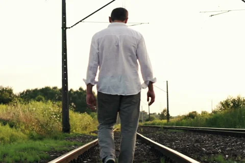 Young man walking on railroad super slow motion, 240Fps NTSC Stock Footage 40462149