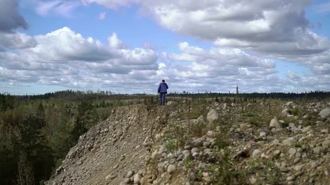 Young man walking on a rocks Stock Footage 72929482