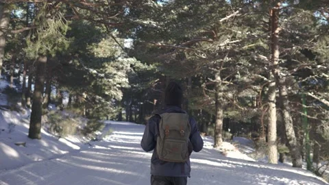 Young man walking on the snow and ice outdoors in the mountains/woods Stock Footage 164847461