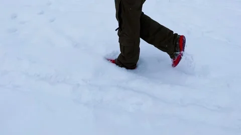 Young man is walking on the snow 動画素材 132869698