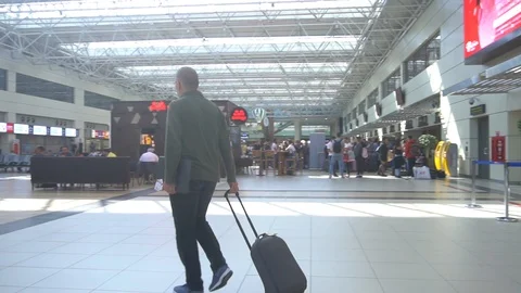 Young Man Walking With Suitcase On The Terminal Stock Footage 105805571