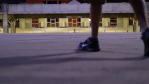 Young Man Walking Through Parking Garage At Night Video stock 99427229