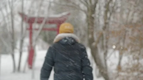 Young man is walking through the snow 動画素材 130698260