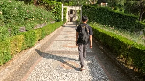Young Man Walking Through Tivoli Garden Path Rome Italy Sunny Day Vidéo 333690384