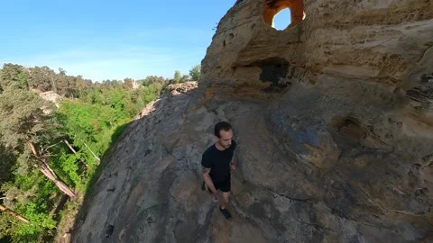 Young man walking trail at the Klusfelsen sandstones in the Harz region Germany. Stock Footage 194581457