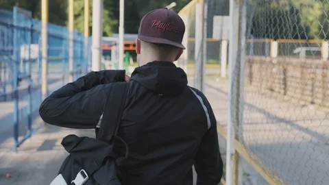 Young man walking for training. Back view of sportsman in cap. Sport concept Video stock 115020560