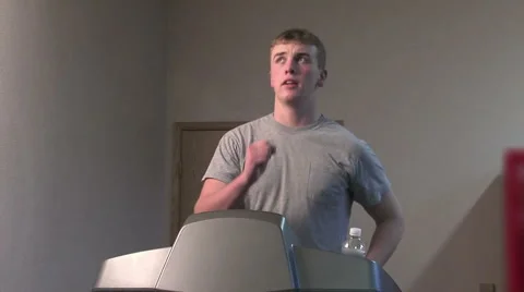 Young man walking on a treadmill Stock Footage 49862953