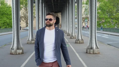 Young man is walking under the bridge of Bir-Hakeim in Paris Stock Footage 107433247