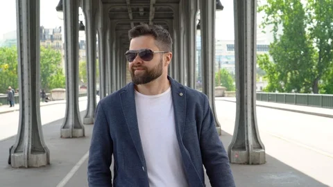 Young man is walking under the bridge of Bir-Hakeim in Paris Stock Footage 107434190