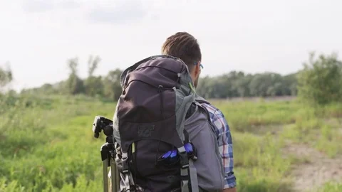 Young Man Walking the Wilderness During Hiking Stock Footage 77677760